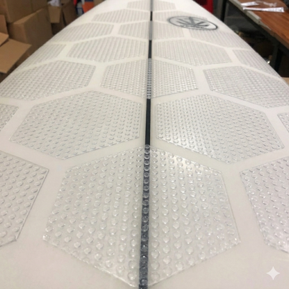 Hex Grip clear dotted traction pads installed on surfboard deck, close-up